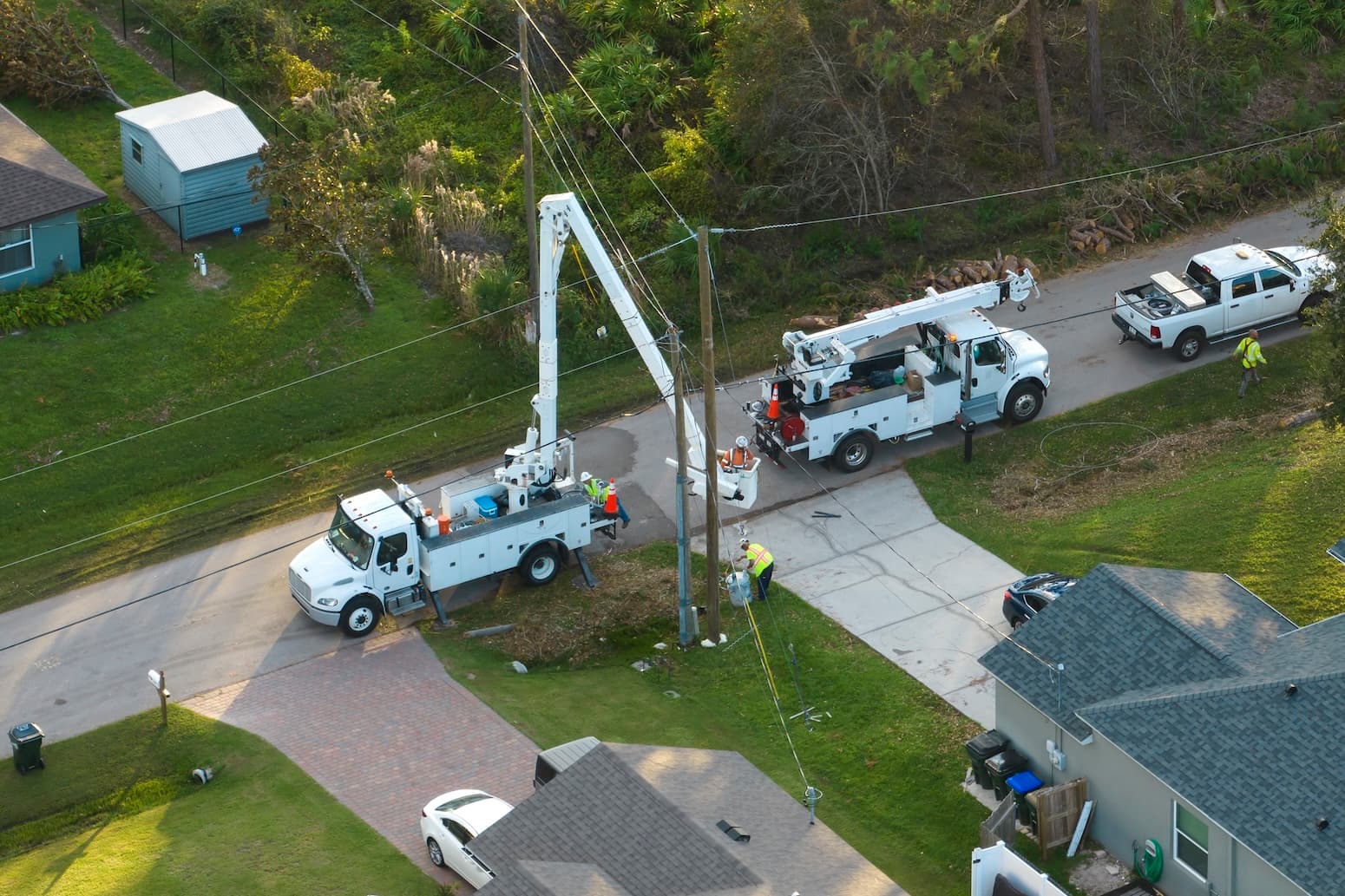 Utility crews working from bucket trucks